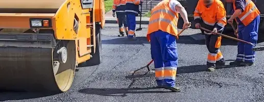 roller on fresh asphalt with crew working
