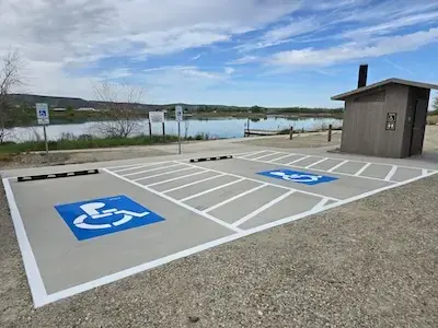 Two handicap stalls by a lake.